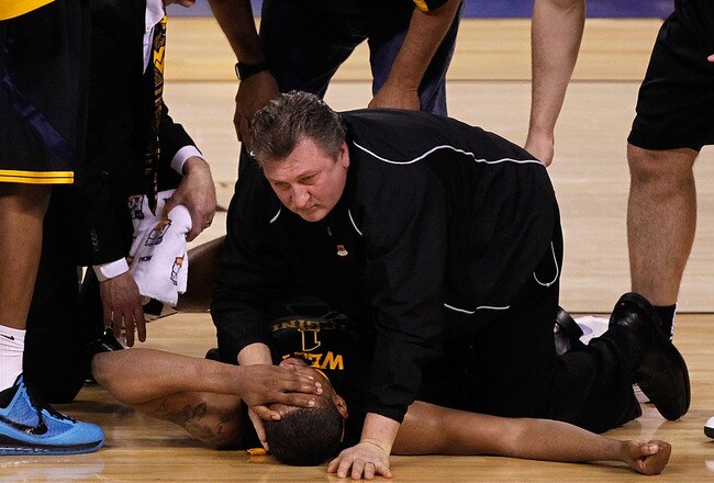 INDIANAPOLIS - APRIL 03:  Head coach Bob Huggins consoles Da'Sean Butler #1 of the West Virginia Mountaineers after Butler injured his knee in the second half against the Duke Blue Devils during the National Semifinal game of the 2010 NCAA Division I Men's Basketball Championship at Lucas Oil Stadium on April 3, 2010 in Indianapolis, Indiana.  (Photo by Jonathan Daniel/Getty Images)