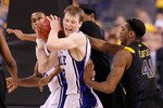 INDIANAPOLIS - APRIL 03:  Kyle Singler #15 of the Duke Blue Devils reacts as he is covered by John Flowers #41 of the West Virginia Mountaineers during the National Semifinal game of the 2010 NCAA Division I Men's Basketball Championship at Lucas Oil Stadium on April 3, 2010 in Indianapolis, Indiana.  (Photo by Kevin C. Cox/Getty Images)