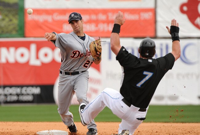 DUNEDIN, FL - MARCH 22: Infielder Scott Sizemore #20 of the Detroit Tigers starts a double play over sliding outfielder Jeremy Reed #7 of  the Toronto Blue Jays March 22, 2010 at Dunedin Stadium in Dunedin, Florida. (Photo by Al Messerschmidt/Getty Images)