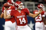 ARLINGTON, TX - SEPTEMBER 05:  Quarterback Sam Bradford #14 of the Oklahoma Sooners warms up before a game against the Brigham Young Cougars at Cowboys Stadium on September 5, 2009 in Arlington, Texas.  (Photo by Ronald Martinez/Getty Images)