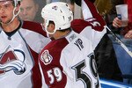 BUFFALO, NY - JANUARY 09: Brandon Yip #59 and Wojtek Wolski #8  of the Colorado Avalanche celebrate Yip's goal in the second period against Patrick Lalime #40 of the Buffalo Sabres as referee Ghislain Hebert #49 looks on at HSBC Arena on January 9, 2010 in Buffalo, New York.  (Photo by Rick Stewart/Getty Images)