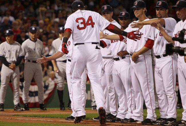 BOSTON - APRIL 04:  David Ortiz #34 of the Boston Red Sox greets his teammates as he is announced before the game against the  the New York Yankees on April 4, 2010 during Opening Night at Fenway Park in Boston, Massachusetts.  (Photo by Elsa/Getty Images)