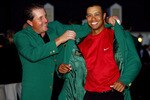 AUGUSTA, GA - APRIL 10:  Tiger Woods is presented with the green jacket by Phil Mickelson after Woods won The Masters at the Augusta National Golf Club on April 10, 2005 in Augusta, Georgia.  (Photo by David Cannon/Getty Images)