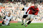 MANCHESTER, ENGLAND - MARCH 14:  Wayne Rooney of Manchester United celebrates scoring the first goal during the Barclays Premier League match between Manchester United and Fulham at Old Trafford on March 14, 2010 in Manchester, England.  (Photo by Michael Regan/Getty Images)