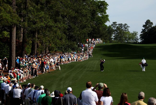 AUGUSTA, GA - APRIL 07:  Tiger Woods plays a shot from a fairway while caddie Steve Williams and a gallery of fans look on during a practice round prior to the 2010 Masters Tournament at Augusta National Golf Club on April 7, 2010 in Augusta, Georgia.  (Photo by Andrew Redington/Getty Images)
