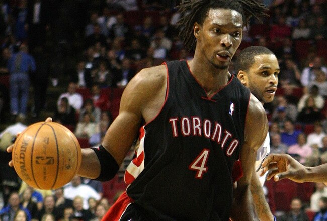 ORLANDO, FL - NOVEMBER 18: Chris Bosh #4 of the Toronto Raptors drives against Dwight Howard #12 of the Orlando Magic during the game on November 18, 2008 at Amway Arena in Orlando, Florida.  NOTE TO USER: User expressly acknowledges and agrees that, by downloading and/or using this Photograph, user is consenting to the terms and conditions of the Getty Images License Agreement.  (Photo by Sam Greenwood/Getty Images)