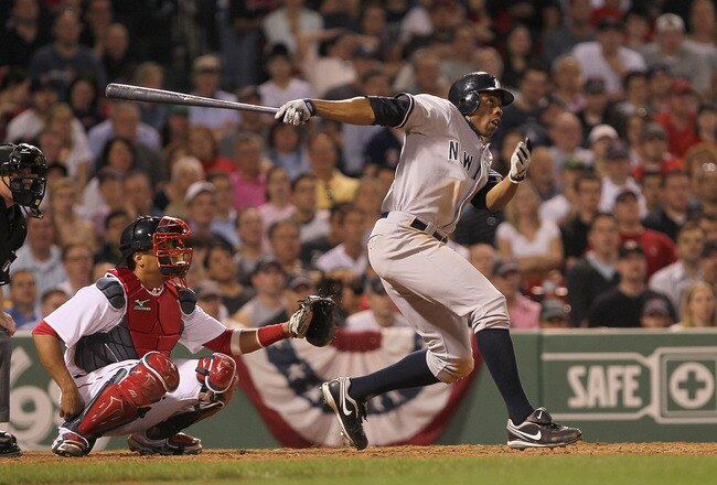 BOSTON - APRIL 07:  Curtis Granderson #14 of the New York Yankees hits a home run in the 10th inning against the Boston Red Sox at Fenway Park on April 7, 2010 in Boston, Massachusetts. (Photo by Jim Rogash/Getty Images)