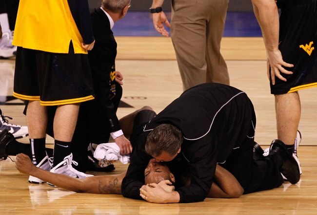 INDIANAPOLIS - APRIL 03:  Head coach Bob Huggins consoles Da'Sean Butler #1 of the West Virginia Mountaineers after Butler injured his knee in the second half against the Duke Blue Devils during the National Semifinal game of the 2010 NCAA Division I Men's Basketball Championship at Lucas Oil Stadium on April 3, 2010 in Indianapolis, Indiana.  (Photo by Jonathan Daniel/Getty Images)