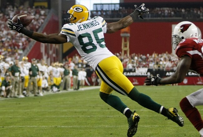 GLENDALE, AZ - JANUARY 10:  Wide receiver Greg Jennings #85 of the Green Bay Packers catches the ball for a touchdown against the Arizona Cardinals during the third quarter of the 2010 NFC wild-card playoff game at University of Phoenix Stadium on January 10, 2010 in Glendale, Arizona.   (Photo by Jeff Gross/Getty Images)