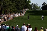 AUGUSTA, GA - APRIL 07:  Tiger Woods plays a shot from a fairway while caddie Steve Williams and a gallery of fans look on during a practice round prior to the 2010 Masters Tournament at Augusta National Golf Club on April 7, 2010 in Augusta, Georgia.  (Photo by Andrew Redington/Getty Images)