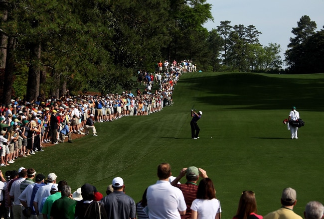 AUGUSTA, GA - APRIL 07:  Tiger Woods plays a shot from a fairway while caddie Steve Williams and a gallery of fans look on during a practice round prior to the 2010 Masters Tournament at Augusta National Golf Club on April 7, 2010 in Augusta, Georgia.  (Photo by Andrew Redington/Getty Images)