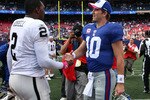 EAST RUTHERFORD, NJ - OCTOBER 11:  Eli Manning #10 of the New York Giants shakes hands with JaMarcus Russell #2 of the Oakland Raiders after their game on October 11, 2009 at Giants Stadium in East Rutherford, New Jersey. The Giants defeated the Raiders 44-7.  (Photo by Jim McIsaac/Getty Images)