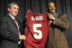 ASHURN, VA - APRIL 6:  Mike Shanahan, head coach of the Washington Redskins presents Donovan McNabb with his new jersey during a press conference on April 6, 2010 at Redskin Park in Ashburn, Virginia.  (Photo by Mitchell Layton/Getty Images)