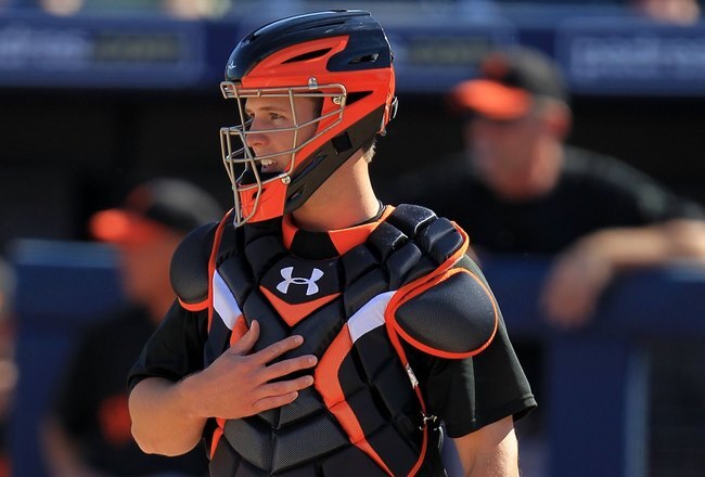 PEORIA, AZ - MARCH 03:  Buster Posey #28 of the San Francisco Giants catches against the Seattle Mariners during a spring training game at Peoria Sports Complex on March 3, 2010 in Peoria, Arizona.  (Photo by Chris McGrath/Getty Images)