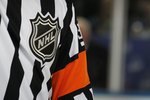 BUFFALO, NY - MARCH 10: A referee handles the game between the Buffalo Sabres and the Dallas Stars at the HSBC Arena on March 10, 2010 in Buffalo, New York.  (Photo by Bruce Bennett/Getty Images)