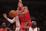 NEW YORK - FEBRUARY 17:  Derrick Rose #1 of the Chicago Bulls lays the ball up between Danilo Gallinari #8 and Chris Duhon #1 of the New York Knicks at Madison Square Garden on February 17, 2010 in New York, New York. NOTE TO USER: User expressly acknowledges and agrees that, by downloading and or using this photograph, User is consenting to the terms and conditions of the Getty Images License Agreement.  (Photo by Nick Laham/Getty Images)