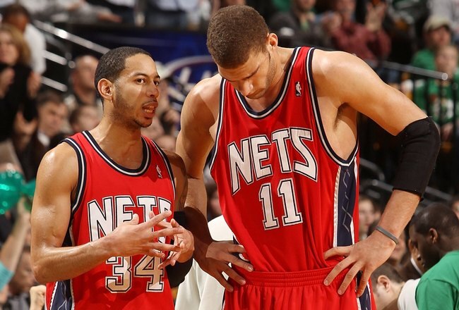 BOSTON - FEBRUARY 27:  Devin Harris #34 of the New Jersey Nets talks with Brook Lopez #11 during a time out against the Boston Celtics at the TD Garden on February 27, 2010 in Boston, Massachusetts. The Nets defeated the Celtics 104-96.  NOTE TO USER: User expressly acknowledges and agrees that, by downloading and or using this photograph, User is consenting to the terms and conditions of the Getty Images License Agreement.  (Photo by Elsa/Getty Images)