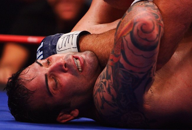 HOLLYWOOD, FL - SEPTEMBER 20:  Ricco Rodriguez of the New York Pit Bulls takes a forarm to the throat by Ben Rothwell of the Quad Cities Silverbacks in their Heavyweight bout during the the International Fight League World Championship Finals on September 19, 2007 at the Hard Rock Hotel and Casino in  Hollywood, Florida  The International Fight League is the worlds first team based professional mixed martial arts league.  In a match, two teams compete against each other with the winning team being the one whose members win three of five one on one matches in five weight divisions.  Competition goes in a round robin format amongst 12 teams with the teams with the two best records ultimately competing for the IFL Championship.  (Photo by Al Bello/Getty Images)