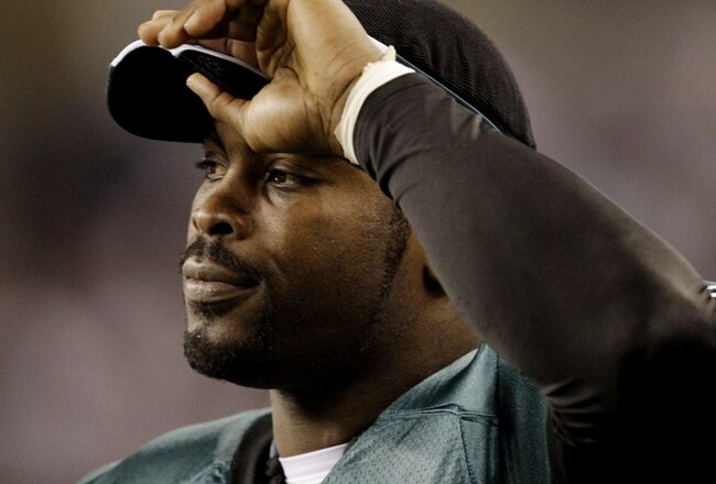 ARLINGTON, TX - JANUARY 9:  Michael Vick #7 of the Philadelphia Eagles looks on from the sideline in the second quarter against the Dallas Cowboys during the 2010 NFC wild-card playoff game at Cowboys Stadium on January 9, 2010 in Arlington, Texas. (Photo by Jamie Squire/Getty Images)