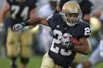 SOUTH BEND, IN - OCTOBER 03: Golden Tate #23 of the Notre Dame Fighting Irish runs against the Washington Huskies on his way to a 67 yard touchdown on October 3, 2009 at Notre Dame Stadium in South Bend, Indiana. (Photo by Jonathan Daniel/Getty Images)