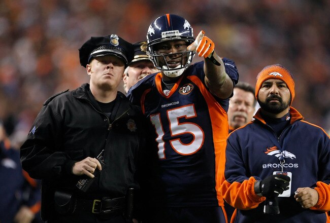 DENVER - DECEMBER 20:  Brandon Marshall #15 of the Denver Broncos points out a disturbance in the crowd to a police officer in the second half against the Oakland Raiders at Invesco Field at Mile High on December 20, 2009 in Denver, Colorado. The Raiders defeated the Broncos 20-19.  (Photo by Jeff Gross/Getty Images)