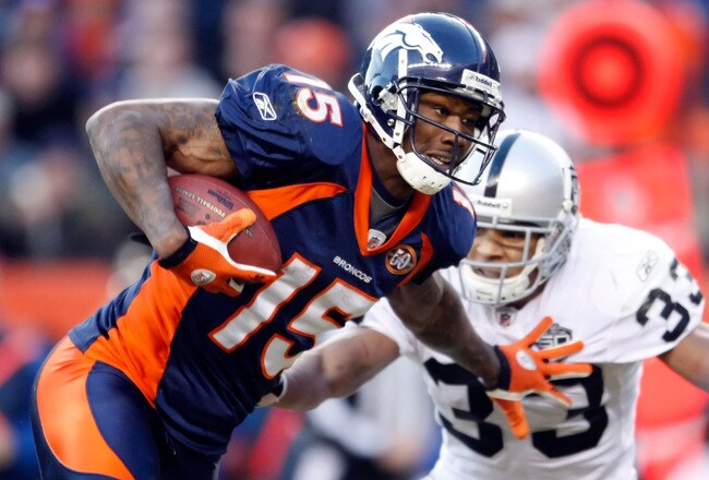 DENVER - DECEMBER 20:  Brandon Marshall #15 of the Denver Broncos stiff arms Tyvon Branch #33 of the Oakland Raiders in the second half at Invesco Field at Mile High on December 20, 2009 in Denver, Colorado. The Raiders defeated the Broncos 20-19.  (Photo by Jeff Gross/Getty Images)