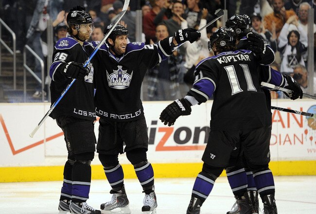LOS ANGELES, CA - APRIL 01:  Jarret Stoll #28 of the Los Angeles Kings celebrates his goal with Michal Handzus #26 and Anze Kopitar #11 for a 4-0 lead over the Vancouver Canucks during the second period at the Staples Center on April 1, 2010 in Los Angeles, California.  (Photo by Harry How/Getty Images)