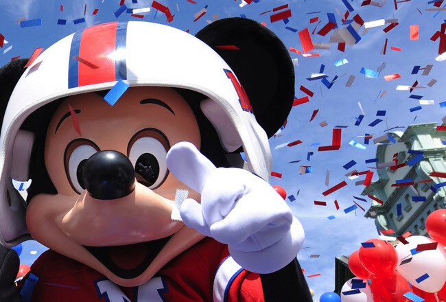 LAKE BUENA VISTA, FL - FEBRUARY 08:  In this handout photo provided by Disney, Super Bowl XLIV MVP Drew Brees joins Mickey Mouse in a celebratory parade in the Magic Kingdom on February 8, 2010 in Lake Buena Vista, Florida.  Brees, the quarterback of the New Orleans Saints, is the latest celebrity to star in the 'I'm Going to Disney World!' and 'I'm Going to Disneyland' commercials which aired only hours after last night's NFL championship game ended.  Brees led his team to a 31-17 victory over the AFC champion Indianapolis Colts in Super Bowl XLIV in Miami.  (Photo by David Roark/Disney via Getty Images)