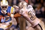 OAKLAND, CA - SEPTEMBER 14:  Antonio Gates #85 of the San Diego Chargers is tackled by Tyvon Branch #33 of the Oakland Raiders during their game on September 14, 2009 at the Oakland-Alameda County Coliseum in Oakland, California.  (Photo by Ezra Shaw/Getty Images)