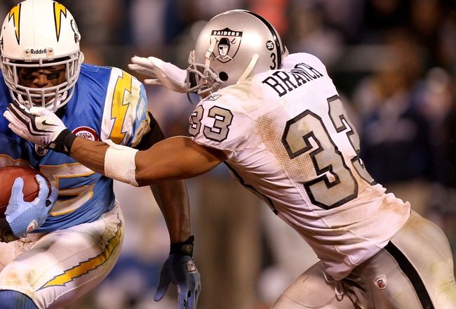 OAKLAND, CA - SEPTEMBER 14:  Antonio Gates #85 of the San Diego Chargers is tackled by Tyvon Branch #33 of the Oakland Raiders during their game on September 14, 2009 at the Oakland-Alameda County Coliseum in Oakland, California.  (Photo by Ezra Shaw/Getty Images)