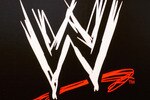 NEW YORK - MARCH 18:  The World Wrestling Entertainment logo hangs on a wall at a media conference announcing the all-star lineup of WWE WrestleMania XIX at ESPN Zone in Times Square March 18, 2003 in New York City.  (Photo by Mark Mainz/Getty Images)