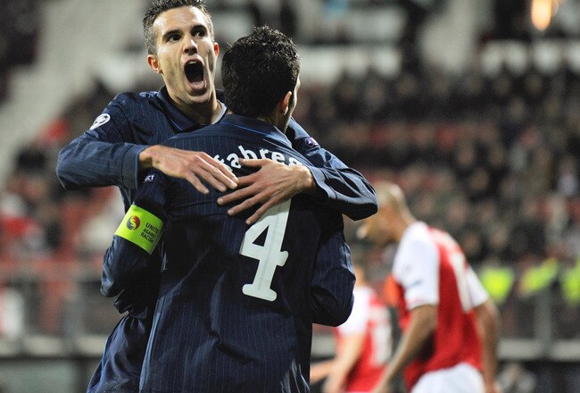 ALKMAAR, NETHERLANDS - OCTOBER 20: Cesc Fabregas of Arsenal celebrates with Robin van Persie after scoring the first goal during the UEFA Champions League Group H match between AZ Alkmaar and Arsenal at the DSB Stadium on October 20, 2009 in Alkmaar, Netherlands.  (Photo by Michael Regan/Getty Images)