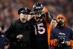 DENVER - DECEMBER 20:  Brandon Marshall #15 of the Denver Broncos points out a disturbance in the crowd to a police officer in the second half against the Oakland Raiders at Invesco Field at Mile High on December 20, 2009 in Denver, Colorado. The Raiders defeated the Broncos 20-19.  (Photo by Jeff Gross/Getty Images)