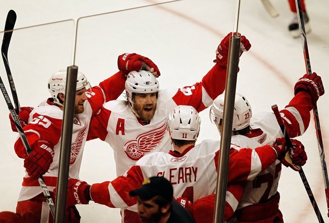 CHICAGO - APRIL 11: Niklas Kronwall #55 and Henrik Zetterberg #40 of the Detroit Red Wings celebrate the winning goal against the Chicago Blackhawks by teammate Brad Stuart at the United Center on April 11, 2010 in Chicago, Illinois. The Red Wings defeated the Blackhawks 3-2 in overtime. (Photo by Jonathan Daniel/Getty Images)