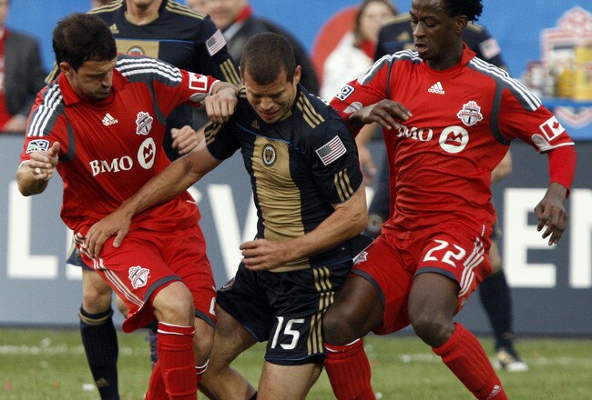 TORONTO - APRIL 15: Martin Saric #25 and Amadou Sanyang #22 of Toronto FC rub out Alejandro Moreno #15 of Philadelphia Union during action at BMO Field April 15, 2010 in Toronto, Ontario, Canada. (Photo by Abelimages/Getty Images)