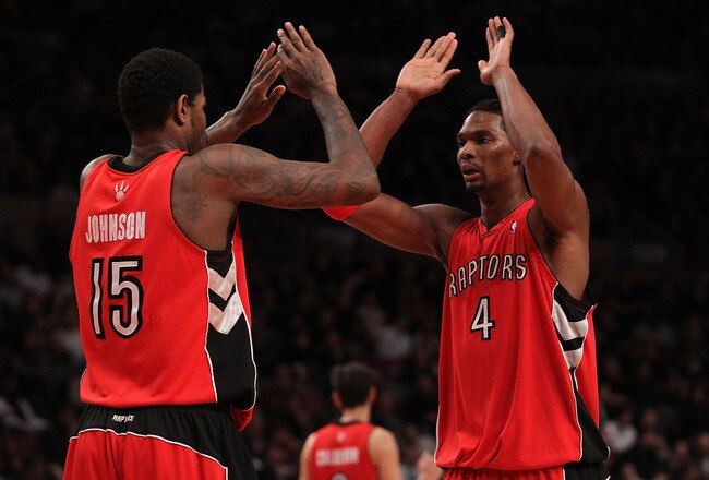 NEW YORK - JANUARY 28:  Chris Bosh #4 of the Toronto Raptors celebrates a basket with teammate Amir Johnson #15 against the New York Knicks at Madison Square Garden on January 28, 2010 in New York, New York. NOTE TO USER: User expressly acknowledges and agrees that, by downloading and or using this photograph, User is consenting to the terms and conditions of the Getty Images License Agreement.  (Photo by Nick Laham/Getty Images)