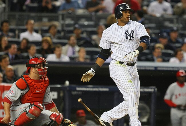 NEW YORK - APRIL 15:  Robinson Cano of the New York Yankees hits a homerun in the bottom of the second inning off pitcher Scott Kazmir #19 of the Los Angeles Angels of Anaheim on April 15, 2010 in the Bronx borough of New York City.  All Major League players joined in wearing #42 today in honor of Jackie Robinson, who broke the color barrier in baseball when he debuted with Brookly Dodgers in 1947.  (Photo by Mike Stobe/Getty Images)