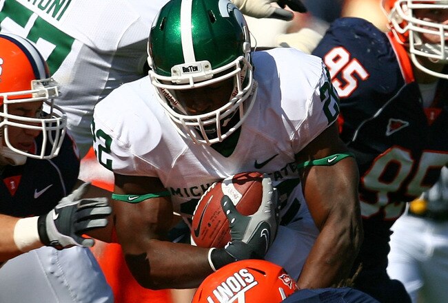 CHAMPAIGN, IL - OCTOBER 10: Larry Caper #22 of the Michigan State Spartans tries to run past Tavon Wilson #3 and Aaron Gress #42 of the Illinois Fighting Illini on October 10, 2009 at Memorial Stadium at the University of Illinois in Champaign, Illinois. Michigan State defeated Illinois 24-14. (Photo by Jonathan Daniel/Getty Images)