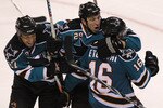 SAN JOSE, CA - APRIL 16:  Devin Stoguchi  #16 of the San Jose Sharks celebrates with teammates Manny Malhotra #27 and Ryane Clowe #29 after scoring the game winning goal in overtime against the Colorado Avalanche in Game Two of the Western Conference Quarterfinals during the 2010 NHL Stanley Cup Playoffs at HP Pavilion on April 16, 2010 in San Jose, California.  (Photo by Jed Jacobsohn/Getty Images)