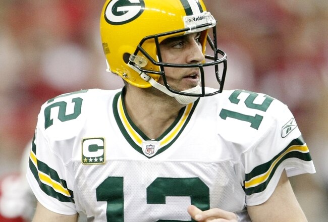 GLENDALE, AZ - JANUARY 10:  Quarterback Aaron Rodgers #12 of the Green Bay Packers drops back to pass against the Arizona Cardinals during the 2010 NFC wild-card playoff game at University of Phoenix Stadium on January 10, 2010 in Glendale, Arizona.   (Photo by Jeff Gross/Getty Images)