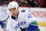 OTTAWA, ON - FEBRUARY 04:  Kyle Wellwood #42 of the Vancouver Canucks plays the puck against the Ottawa Senators during the NHL game at Scotiabank Place on February 4, 2010 in Ottawa, Canada.  (Photo by Phillip MacCallum/Getty Images)
