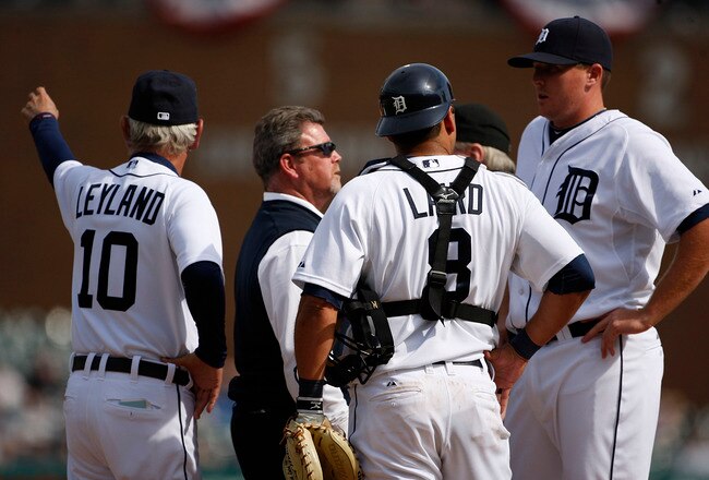 DETROIT - APRIL 11:  Jim Leyland #10 of the Detroit Tigers signals to the bullpen for a replacement as the Tigers trainer Kevin Rand talks with Eddie Bonine #49 in the ninth inning against the Cleveland Indians on April 11, 2010 at Comerica Park in Detroit, Michigan.  (Photo by Leon Halip/Getty Images)