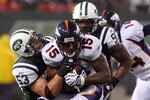 EAST RUTHERFORD, NJ - NOVEMBER 30:  Brandon Marshall #15 of the Denver Broncos is tackled by Cody Spencer #53 of the New York Jets on November 30, 2008 at Giants Stadium in East Rutherford, New Jersey. The Broncos defeated the Jets 34-17.  (Photo by Jim McIsaac/Getty Images)