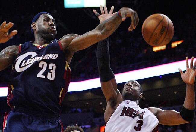 MIAMI - DECEMBER 30:  Dwyane Wade #3 of the Miami Heat has a shot attempt blocked by LeBron James #23 of the Cleveland Cavaliers at American Airlines Arena on December 30, 2008 in Miami, Florida. The Heat defeated the Cavaliers 104-95. NOTE TO USER: User expressly acknowledges and agrees that, by downloading and/or using this Photograph, user is consenting to the terms and conditions of the Getty Images License Agreement.  (Photo by Doug Benc/Getty Images)