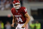 ARLINGTON, TX - SEPTEMBER 05:  Quarterback Sam Bradford #14 of the Oklahoma Sooners lines up for a play at Cowboys Stadium on September 5, 2009 in Arlington, Texas.  (Photo by Ronald Martinez/Getty Images)