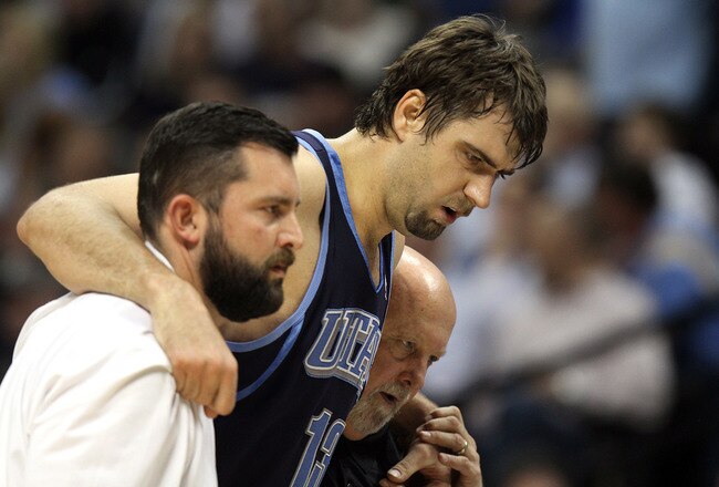 DENVER, CO - APRIL 17 : Mehmet Okur #13 of the Utah Jazz is helped off the court by trainers after twisitng an ankle during the first half of Game One of the Western Conference Quarterfinals of the 2010 NBA Playoffs at the Pepsi Center on April 17, 2010 in Denver, Colorado. Okur was not supposed to return to the game. NOTE TO USER: User expressly acknowledges and agrees that, by downloading and/or using this Photograph, user is consenting to the terms and conditions of the Getty Images License Agreement. (Photo by Marc Piscotty/Getty Images)