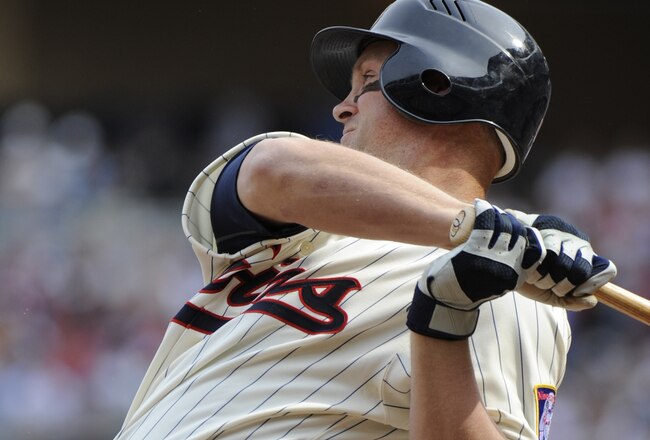 MINNESOTA, MN - APRIL 12: Michael Cuddyer #5 of the Minnesota Twins hits an RBI single in the first inning against the Boston Red Sox during the Twins home opener at Target Field on April 12, 2010 in Minneapolis, Minnesota. (Photo by Hannah Foslien /Getty Images)