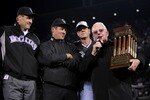 DENVER - OCTOBER 15:  (L-R) Team President Keli McGregor and team owners Charlie Monfort and Dick Monfort of the Colorado Rockies recieve the NLCS trophy after their 6-4 win from the son of Warren C. Giles against the Arizona Diamondbacks during Game Four of the National League Championship Series at Coors Field on October 15, 2007 in Denver, Colorado. The Rockies defeated the Diamondbacks 6-4 to sweep the series 4-0.  (Photo by Doug Pensinger/Getty Images)