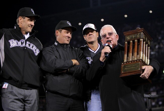 DENVER - OCTOBER 15:  (L-R) Team President Keli McGregor and team owners Charlie Monfort and Dick Monfort of the Colorado Rockies recieve the NLCS trophy after their 6-4 win from the son of Warren C. Giles against the Arizona Diamondbacks during Game Four of the National League Championship Series at Coors Field on October 15, 2007 in Denver, Colorado. The Rockies defeated the Diamondbacks 6-4 to sweep the series 4-0.  (Photo by Doug Pensinger/Getty Images)