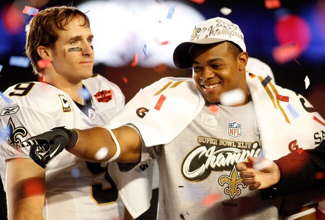 MIAMI GARDENS, FL - FEBRUARY 07:  Drew Brees #9 and Pierre Thomas # 23 of the New Orleans Saints celebrate after defeating the Indianapolis Colts during Super Bowl XLIV on February 7, 2010 at Sun Life Stadium in Miami Gardens, Florida.  (Photo by Chris Graythen/Getty Images)